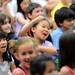 Logan Elementary School second-grader Grace Liu smiles and dances as her teachers dance in a surprise flash mob performance during a year-end assembly on Friday morning. Melanie Maxwell I AnnArbor.com